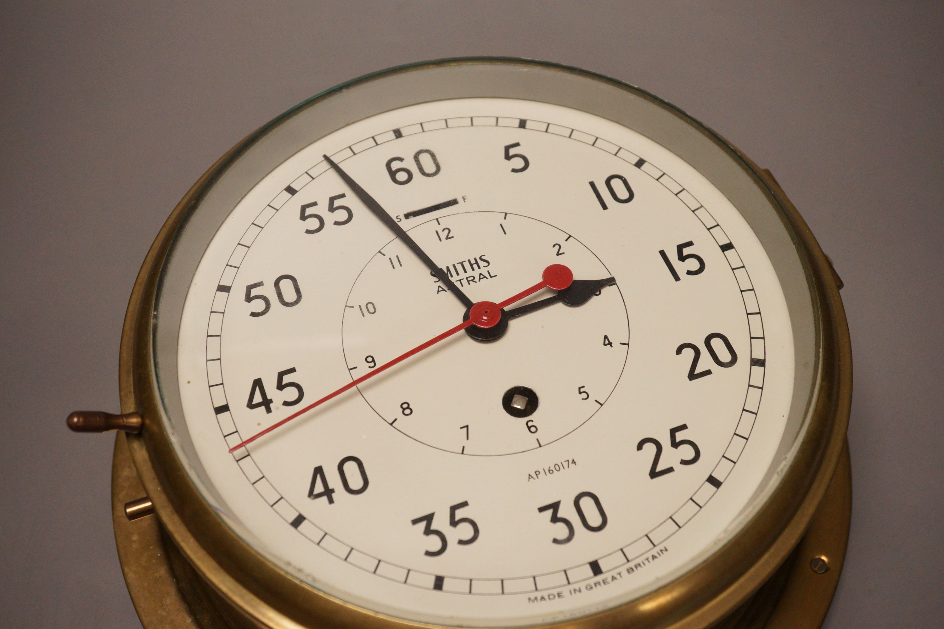 A Smiths Astral brass ships bulkhead timepiece, 27cm